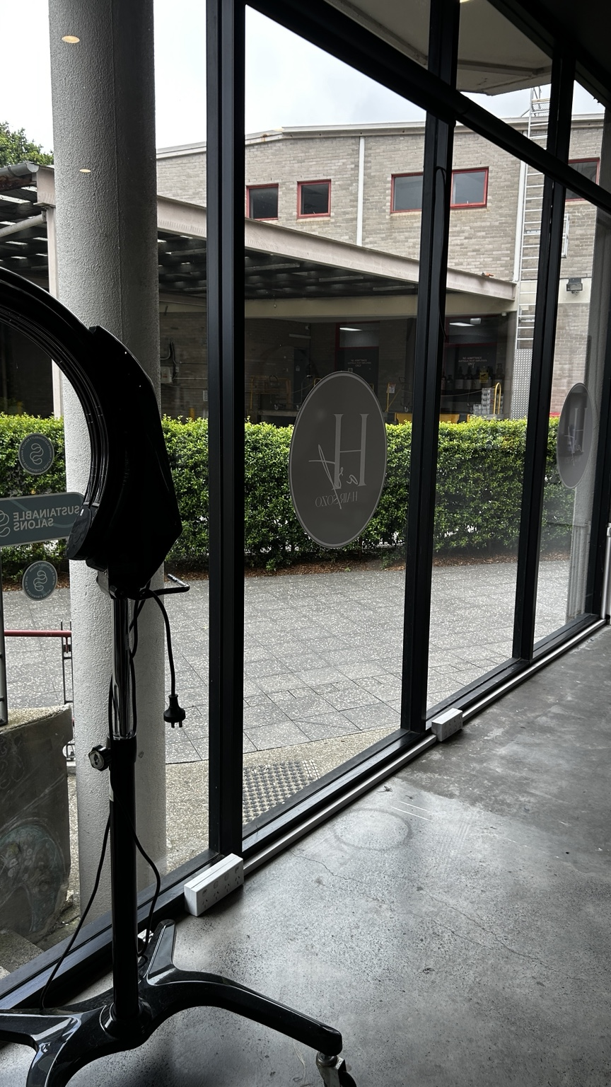 North Shore living room with spotless full-height glass to the pool
